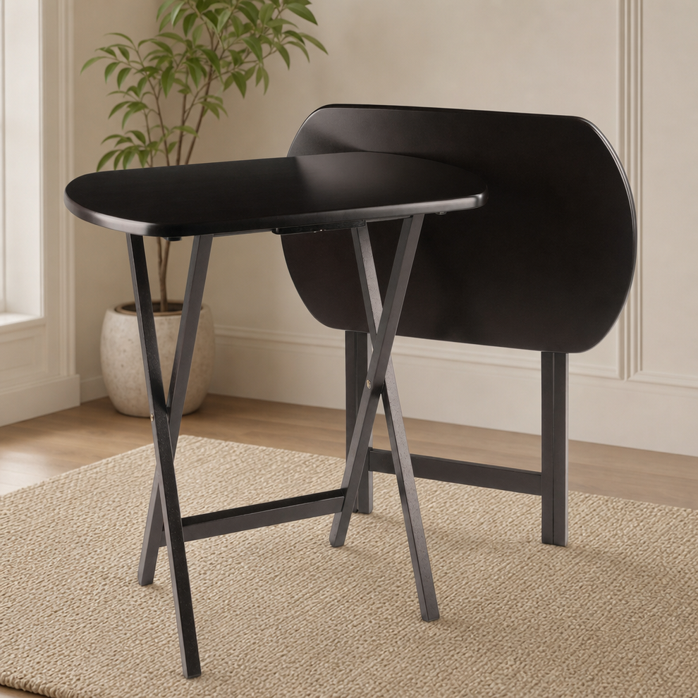 Dark brown folding oblong snack table set, one open and one folded, angled front view in a living room
