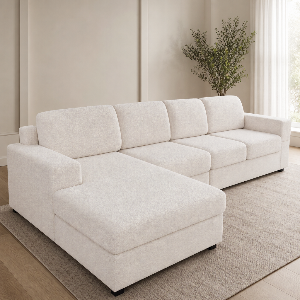 Angled front view of a large cream textured sectional with chaise covered in a stretch cushion cover in a bright living room