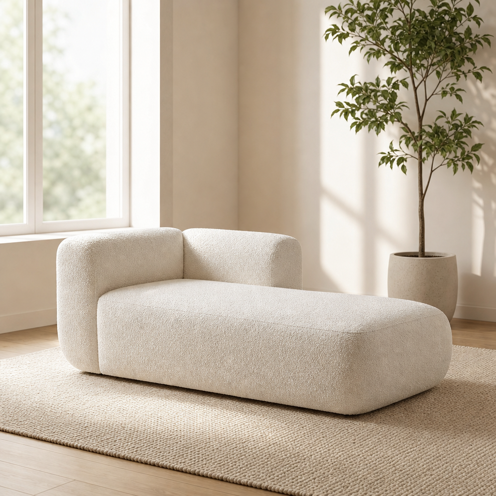 Cream boucle-style chaise lounge angled front-left view in a bright neutral living room