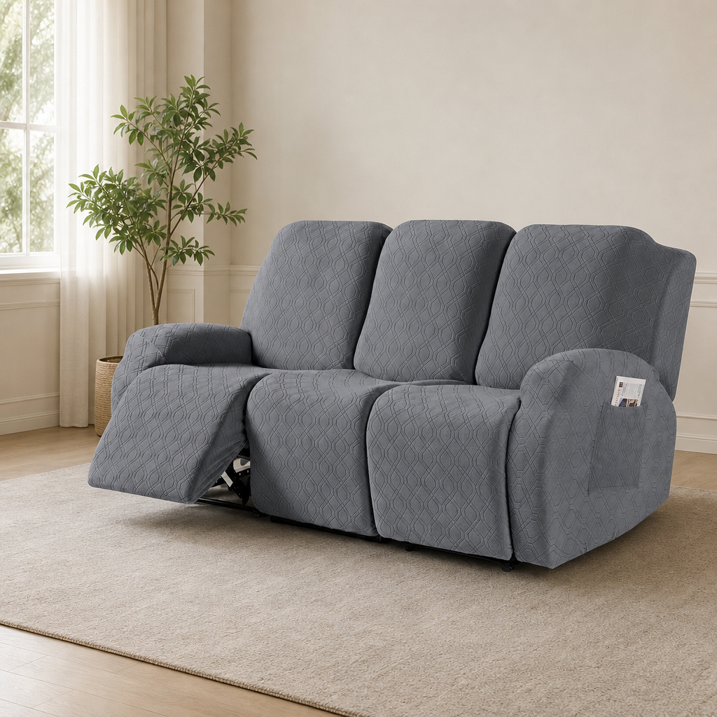 Dark gray textured three-seat recliner slipcover in a living room with left footrest extended