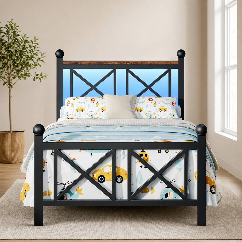 Black platform bed front view with illuminated blue LED headboard and children's car-print bedding