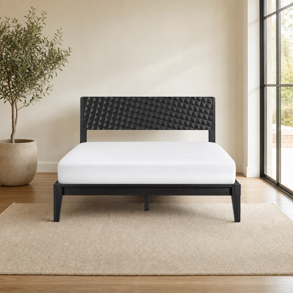 Dark-finish solid wood bed frame front view with 3D geometric carved headboard in a styled bedroom.