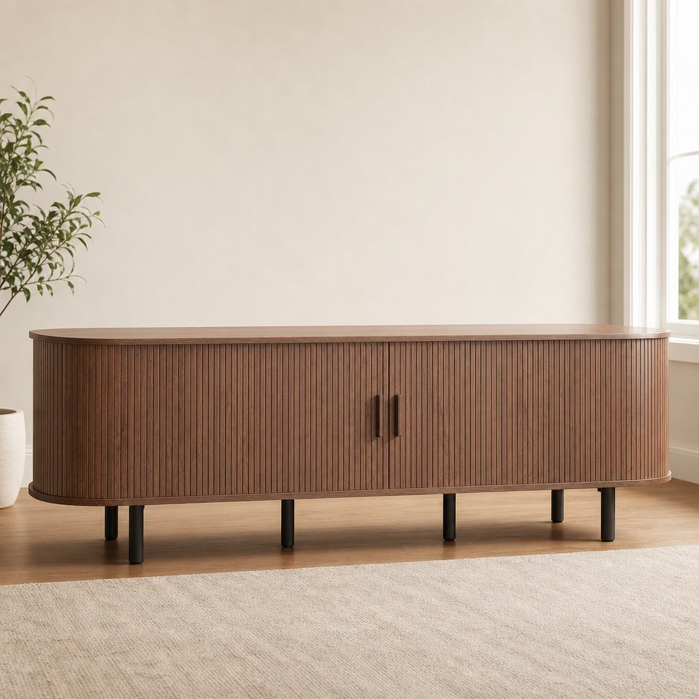 Walnut TV stand front view with vertical slatted sliding doors and black cylindrical legs on a rug-covered floor