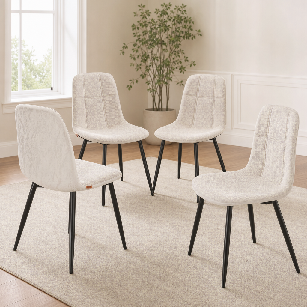 Cream white chenille-front dining chairs with black metal legs, four-chair set arranged on a rug, angled front view