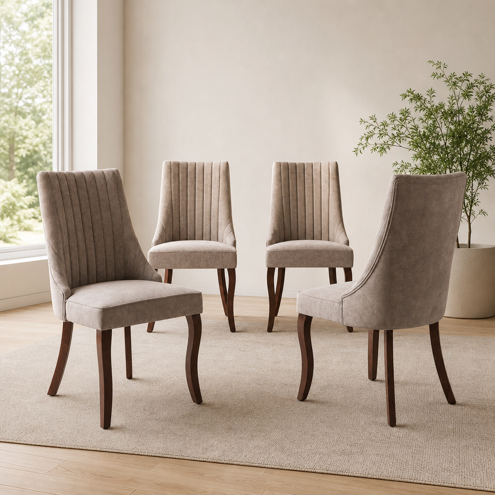 Beige upholstered high-back dining chairs with textured vertical channeling and dark rubberwood legs arranged on a neutralrug