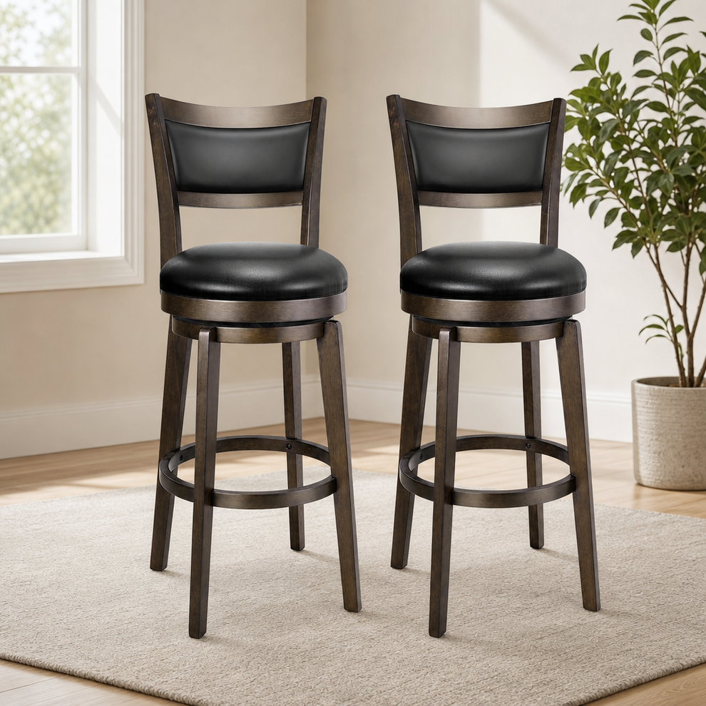 Pair of black faux leather swivel bar stools with rubberwood frames, angled front view in a bright room