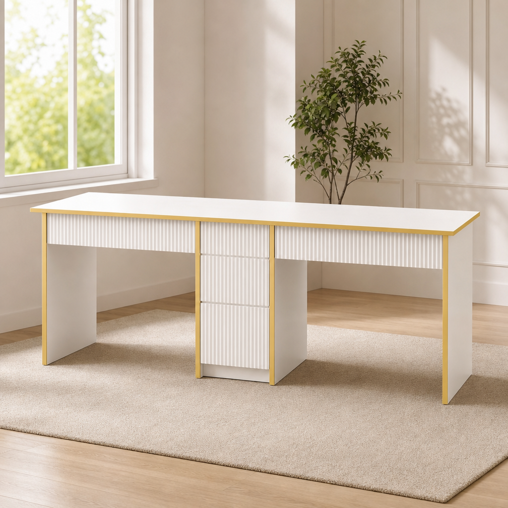 White double computer desk with gold-tone trim and fluted drawer fronts, angled front view in a room
