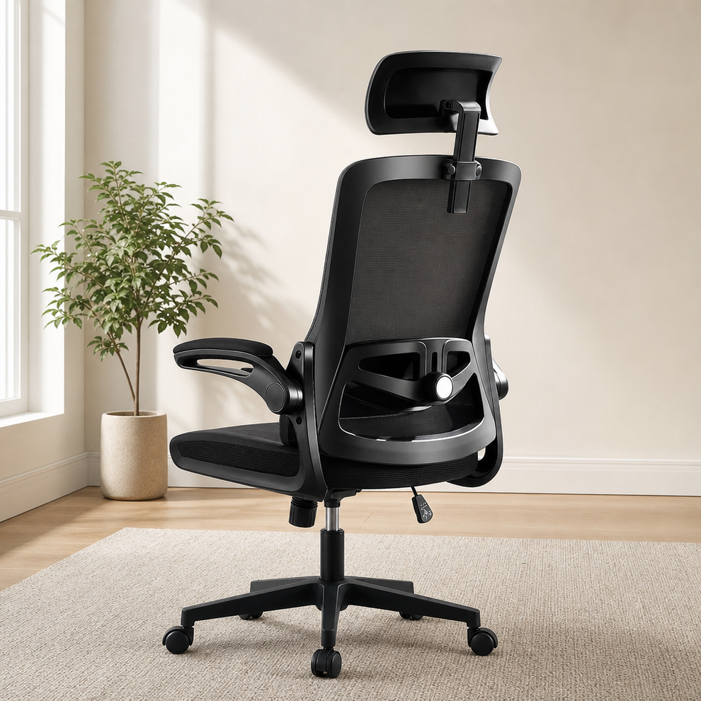 Black high-back mesh office chair rear view with adjustable headrest and five-star base on a rug