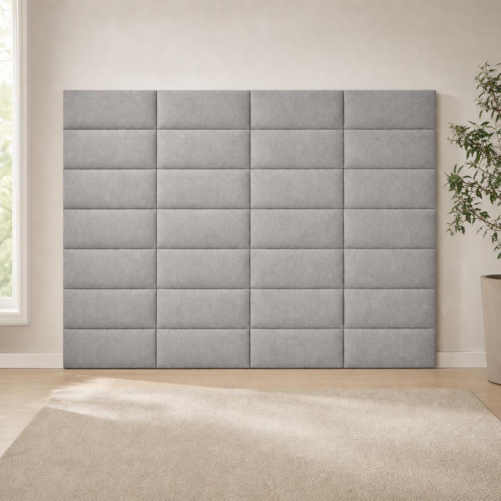 Medium gray fabric headboard panels assembled into a large square grid mounted full-front on a beige wall
