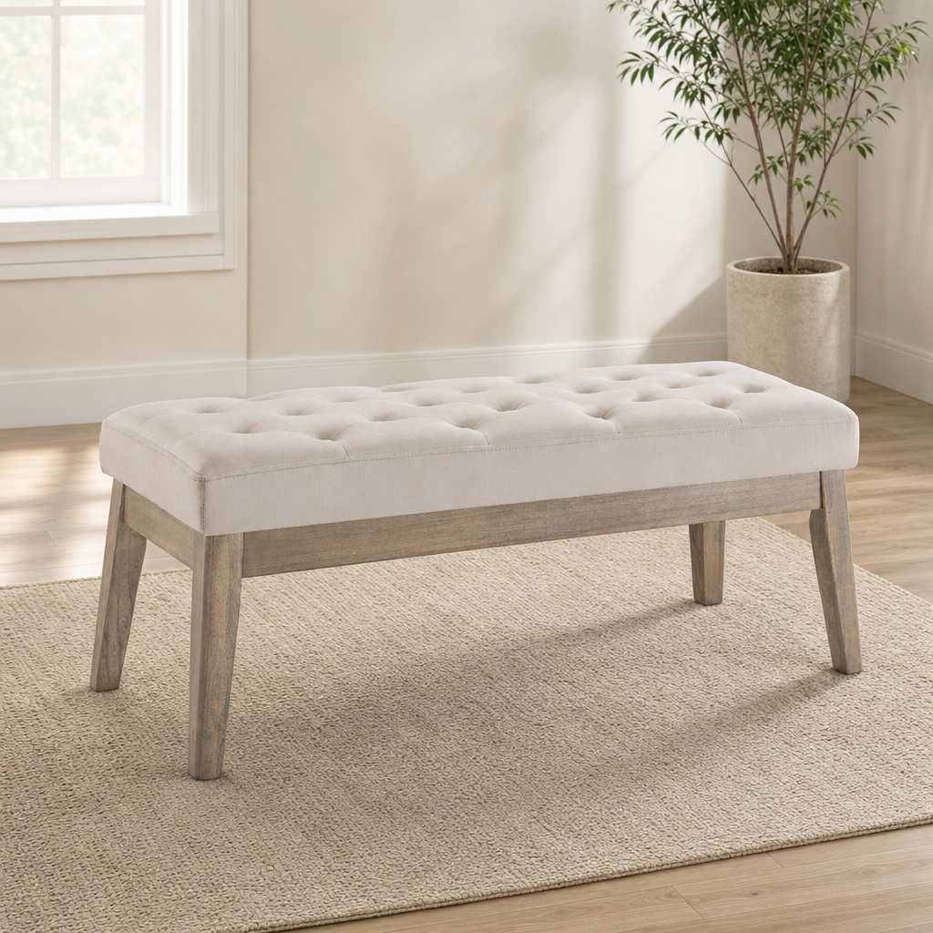 Light taupe velvet tufted bench with wooden base angled front view on a textured rug