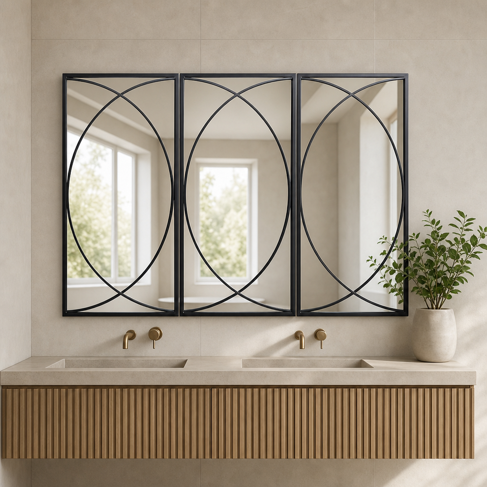Three black-framed rectangular mirrors with circular metal overlay above a double vanity in a neutral bathroom