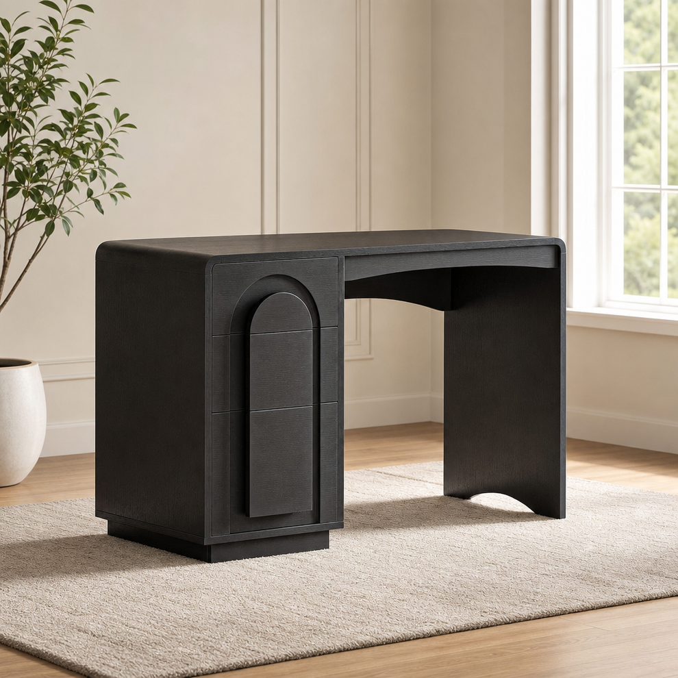 Black 47-inch computer desk angled front view showing drawers and arched tabletop on a neutral rug