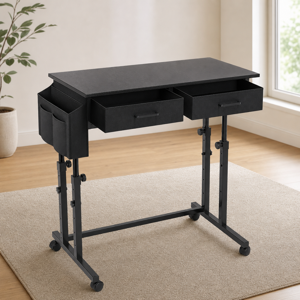 Black standing desk front-left angled view showing two fabric drawers, side storage pocket, metal frame and casters