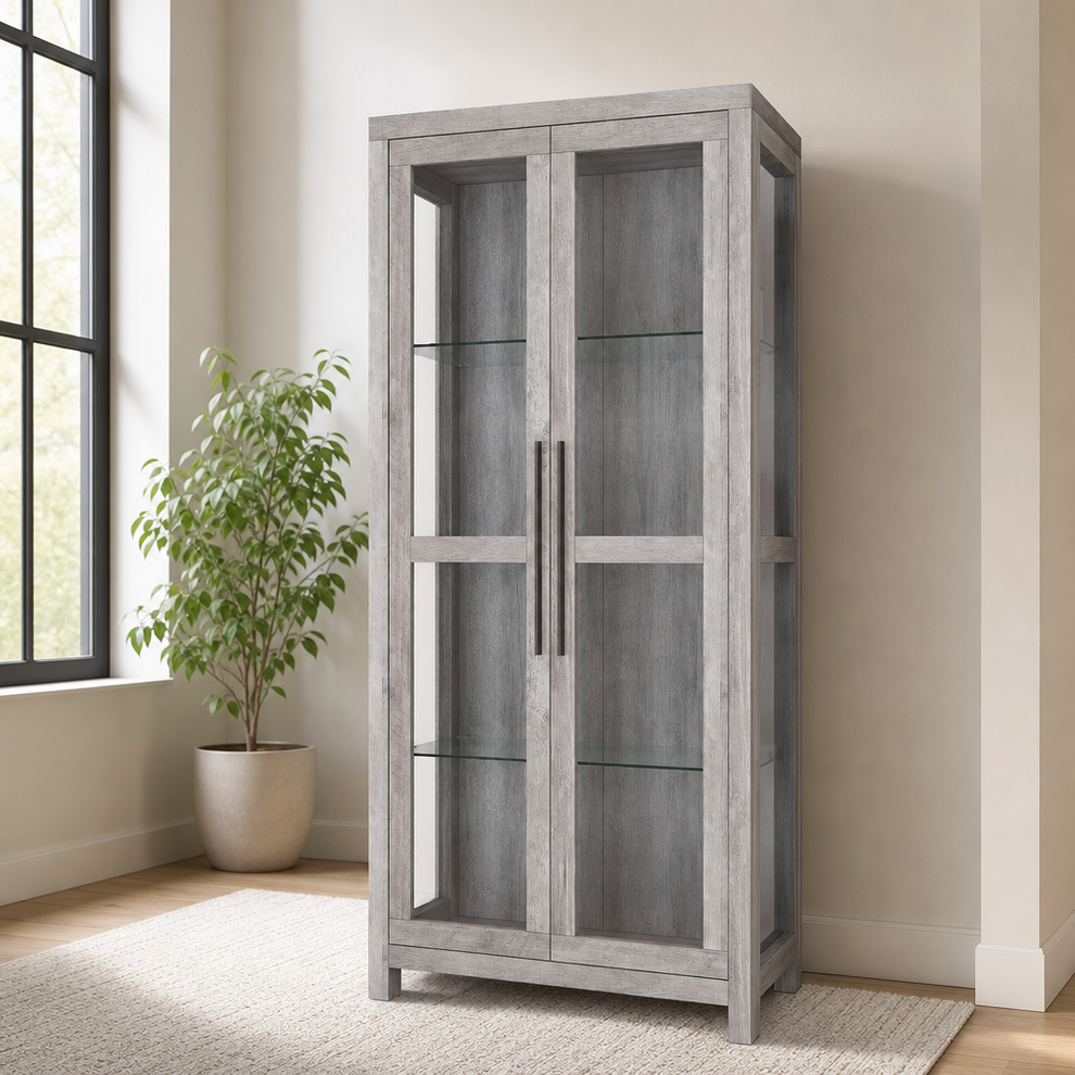 68" Glass Display Cabinet — Manufactured Wood, Tempered Glass Shelves, Gray Wash centered in a warm neutral furnished room