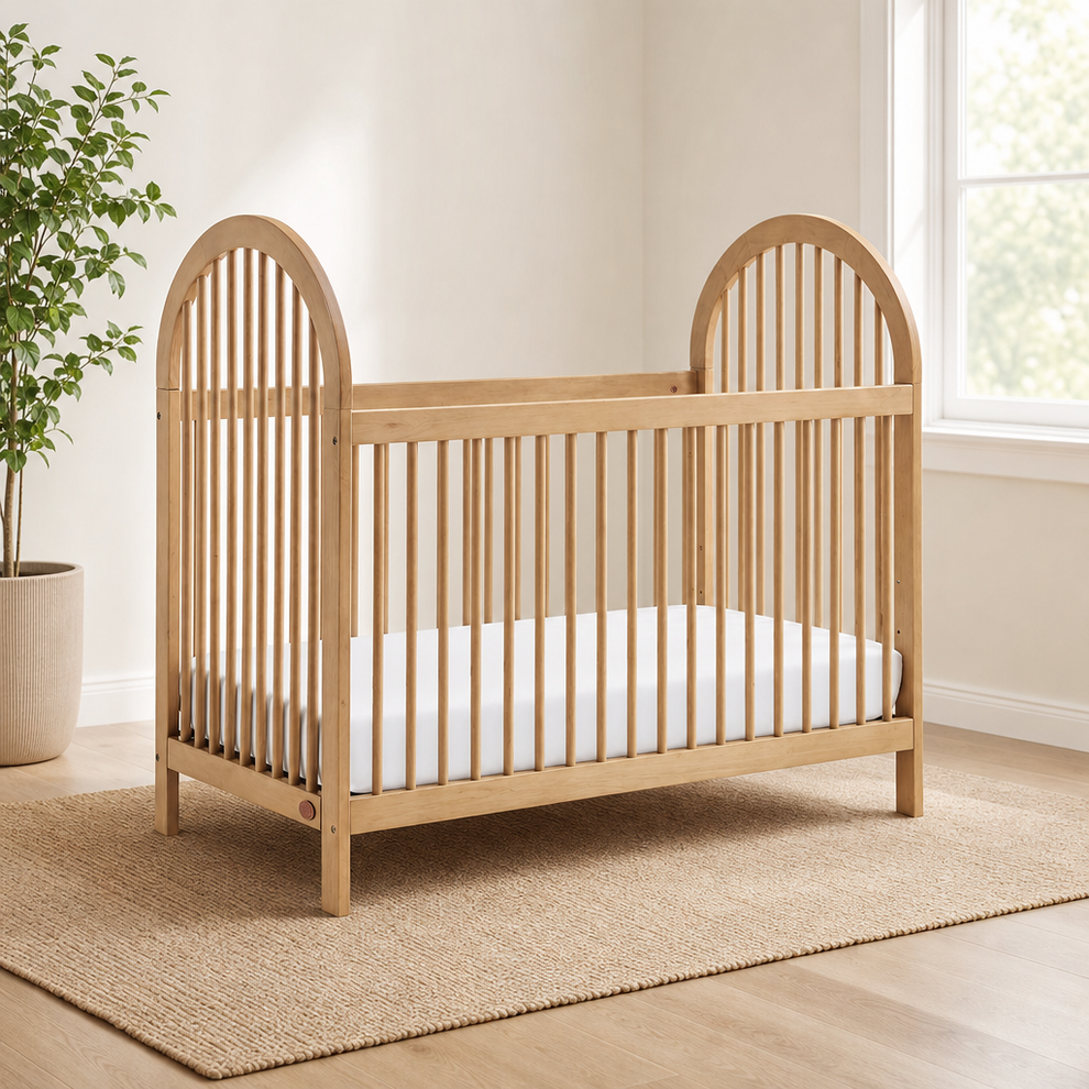 Soho Baby Everlee Convertible Island Crib, Honey Wood centered in a warm neutral furnished room