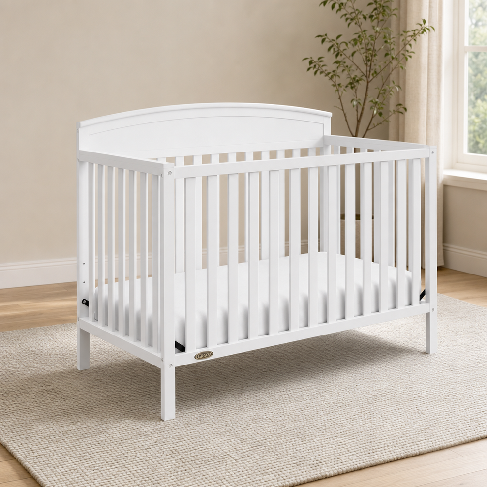 Graco Benton 5-in-1 Convertible Crib centered in a warm neutral furnished room
