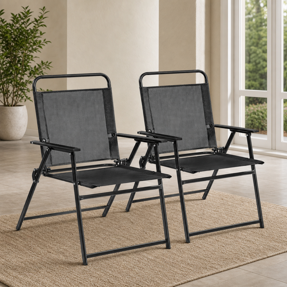 2-Piece Texteline Folding Patio Chairs with Iron Frame — Black centered in a warm neutral furnished room