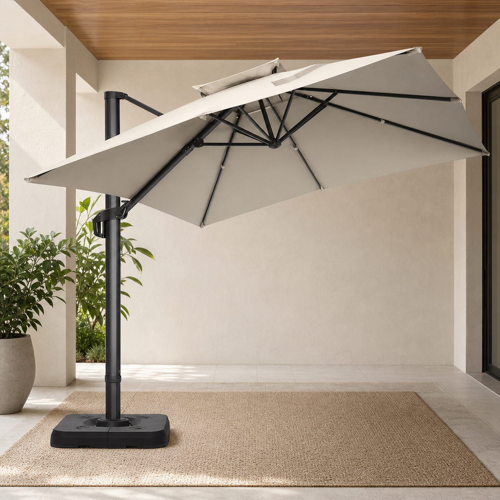 10x10 ft Cantilever Patio Umbrella — Offset Pole, Double-Top Vent, 360° Rotation centered in a warm neutral furnished room