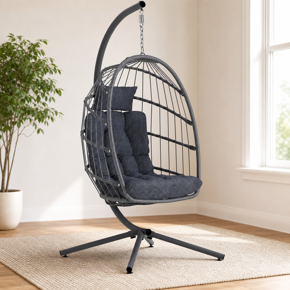Wicker Hanging Egg Chair with Stand & Cushion — All-Weather Wicker & Steel centered in a warm neutral furnished room