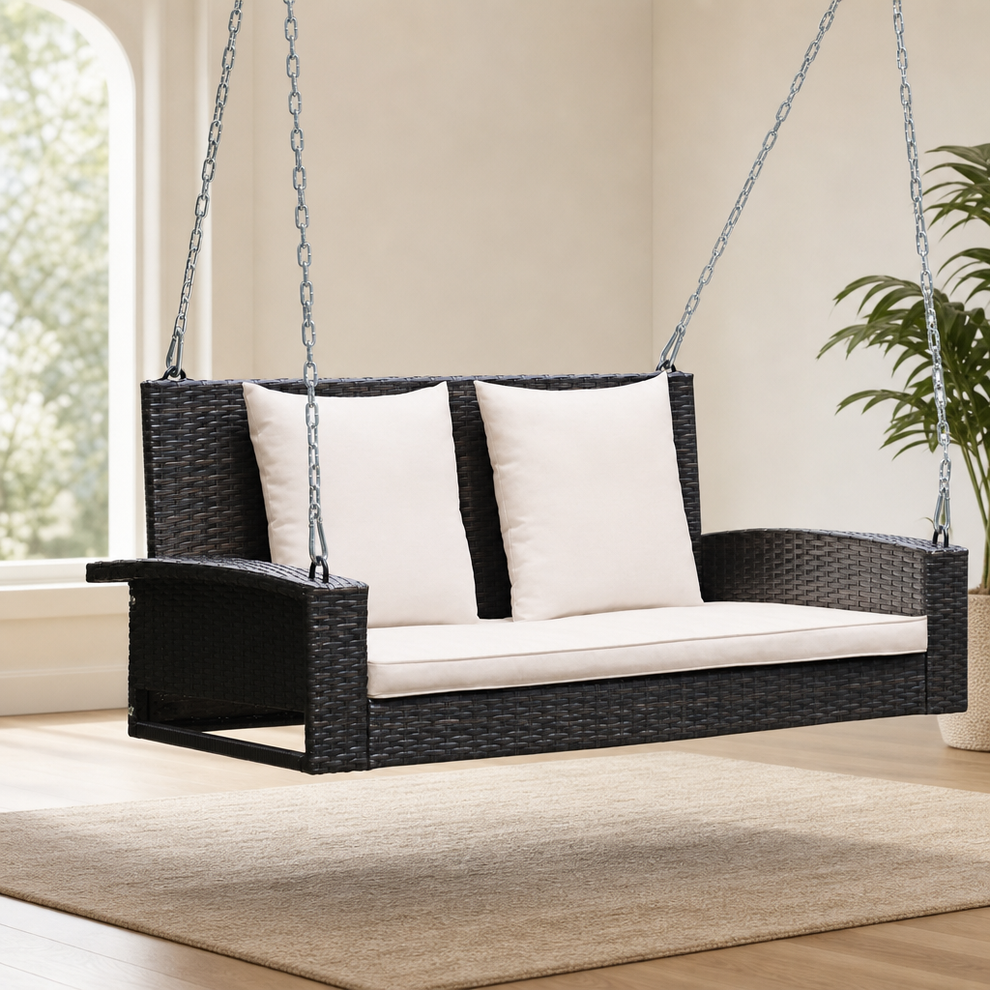 2-Person PE Rattan Hanging Porch Swing with Cushions, Steel Frame centered in a warm neutral furnished room