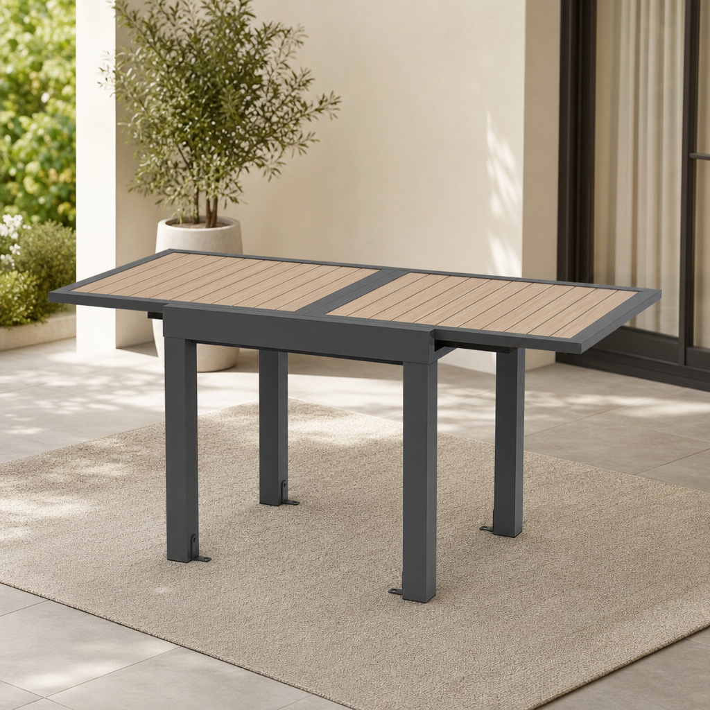 31.5–63 in Aluminum Extendable Patio Table, Seats 4–6 centered in a warm neutral furnished room