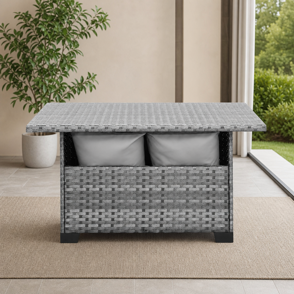 Outdoor Storage Patio Table with HDPE Wicker and Powder-Coated Steel Frame centered in a warm neutral furnished room