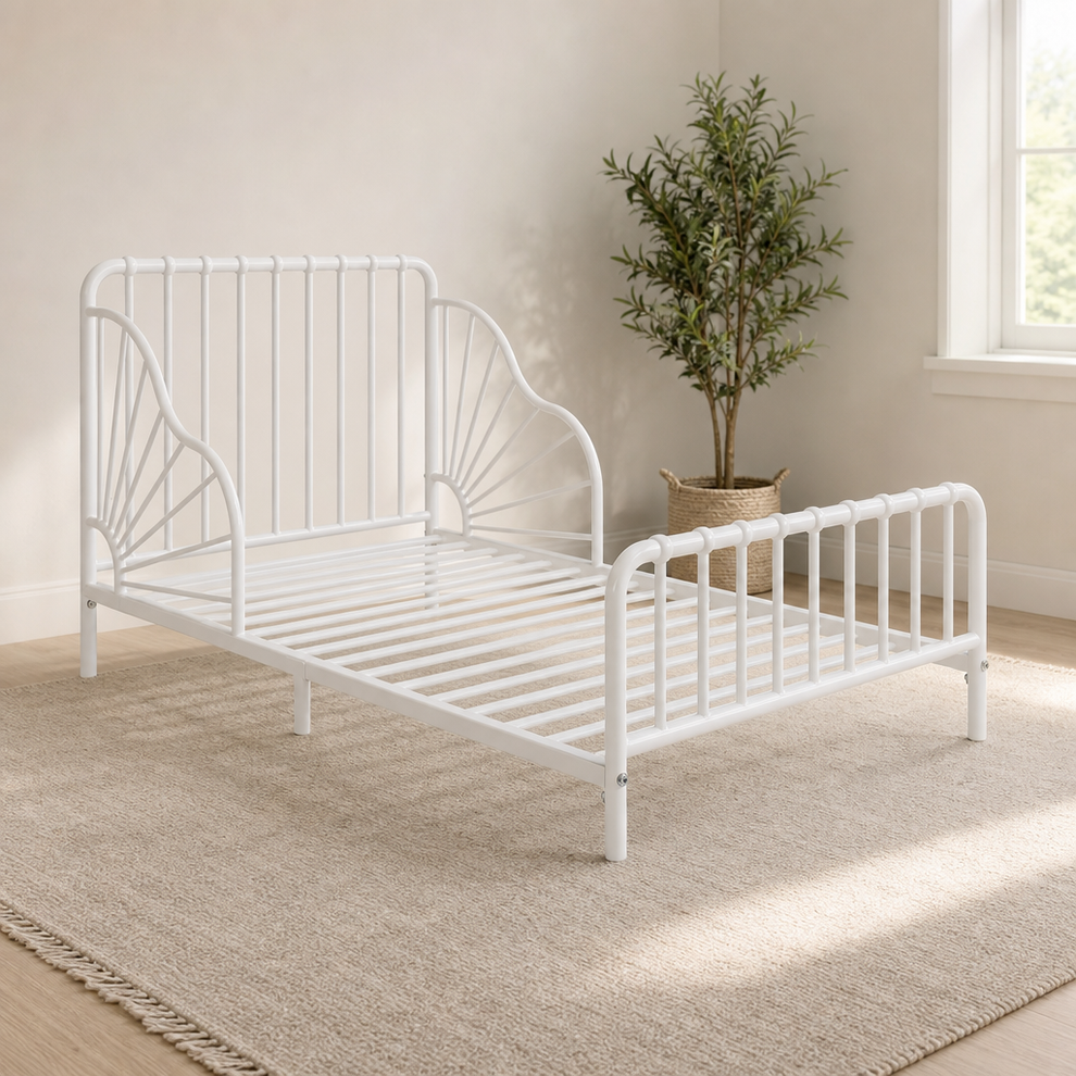 Little Seeds Quinn Whimsical Metal Toddler Bed, Off White centered in a warm neutral furnished room