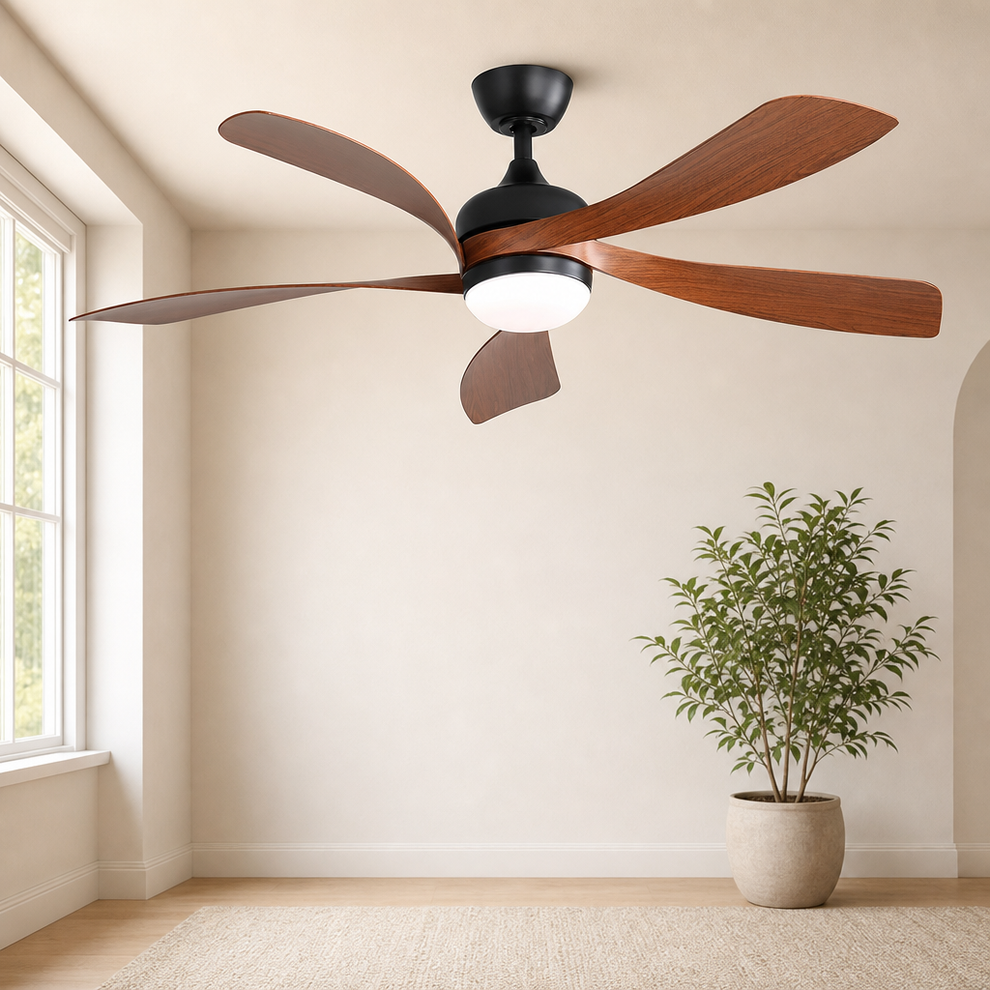 Brown 5-blade ceiling fan with black motor canopy and integrated white LED, angled ceiling view in a bright room with a poted