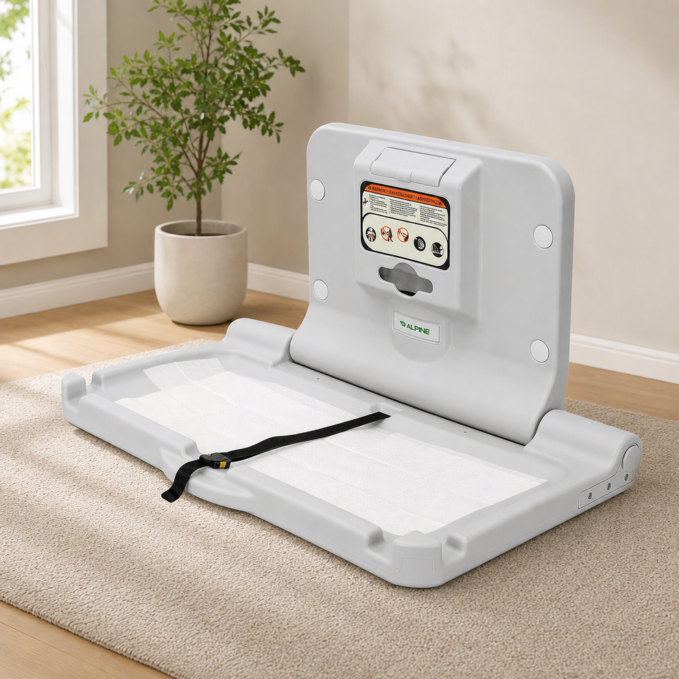 Wall-Mount Fold-Down Baby Changing Station with Safety Straps centered in a warm neutral furnished room
