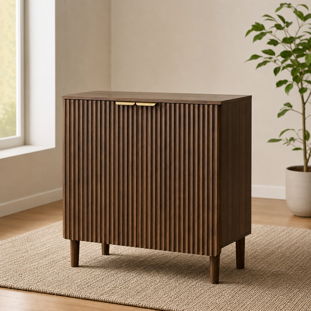 Walnut sideboard with vertical groove-front doors and brass handles, angled front view in a neutral living room