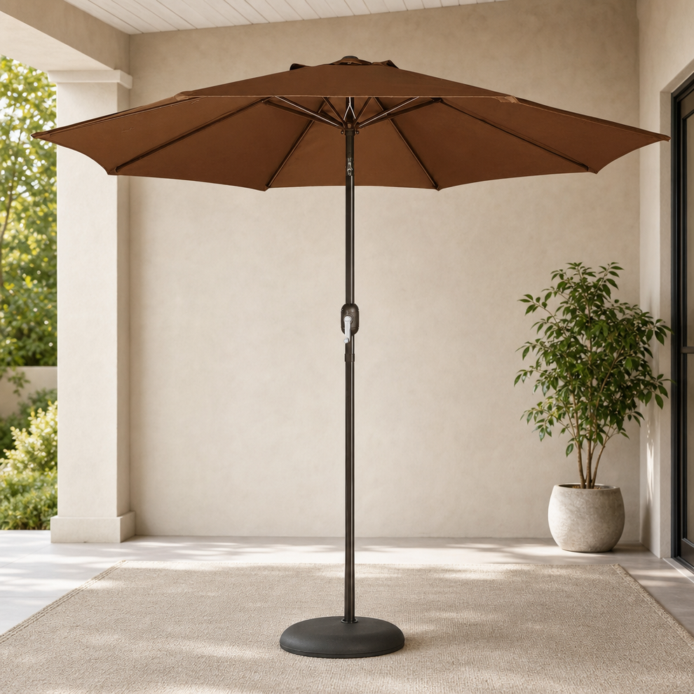 Brown 9' patio umbrella full front view on a covered patio with round base and potted plant