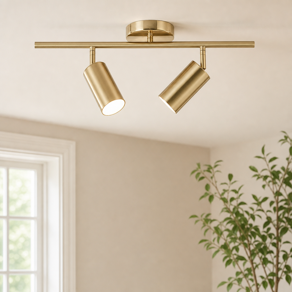 16.5 in Gold-Finish 2-Light Track Ceiling Light with Adjustable Heads centered in a warm neutral furnished room