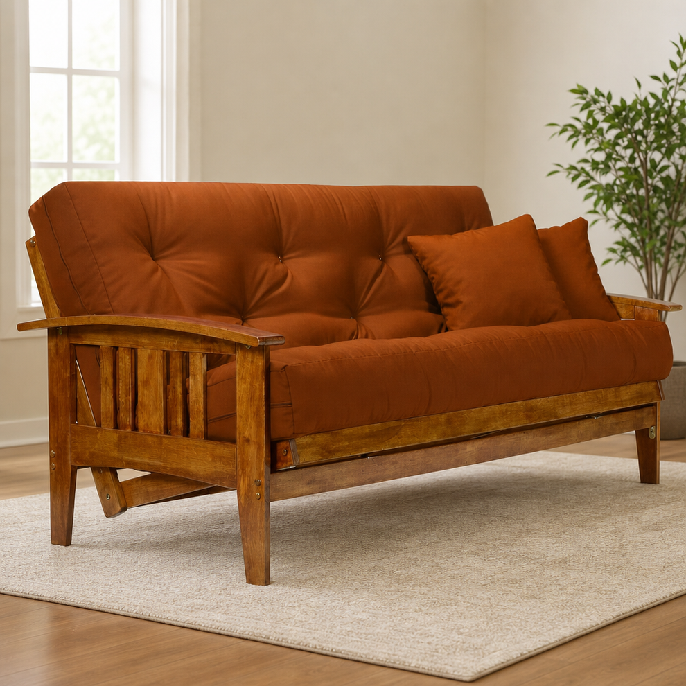 Rust-colored futon mattress on solid wood full-size frame angled front view in a living room