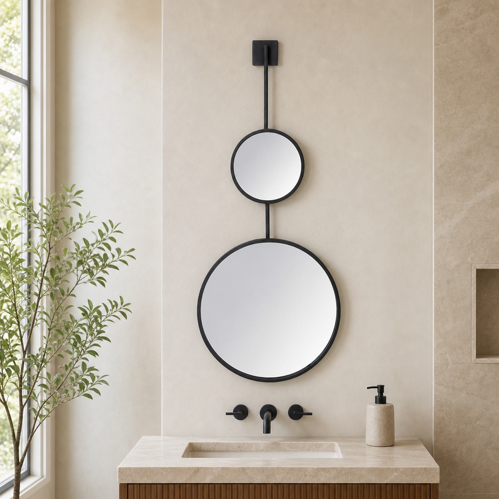 Matte black double-round wall mirror hung above a stone sink in a neutral bathroom, front view.