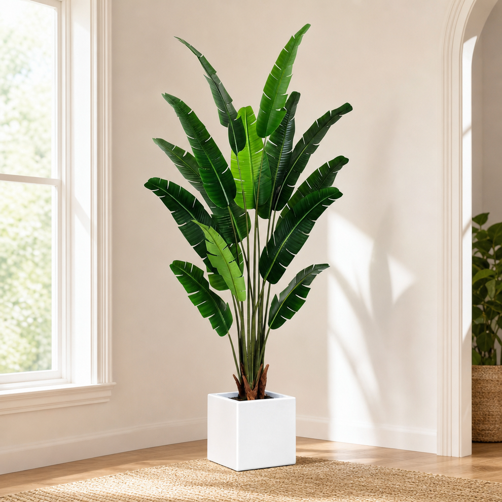 Artificial Bird of Paradise Tree — 7 ft, 14 Hand-Attached Silk Leaves, UV-Protecte centered in a warm neutral furnished room