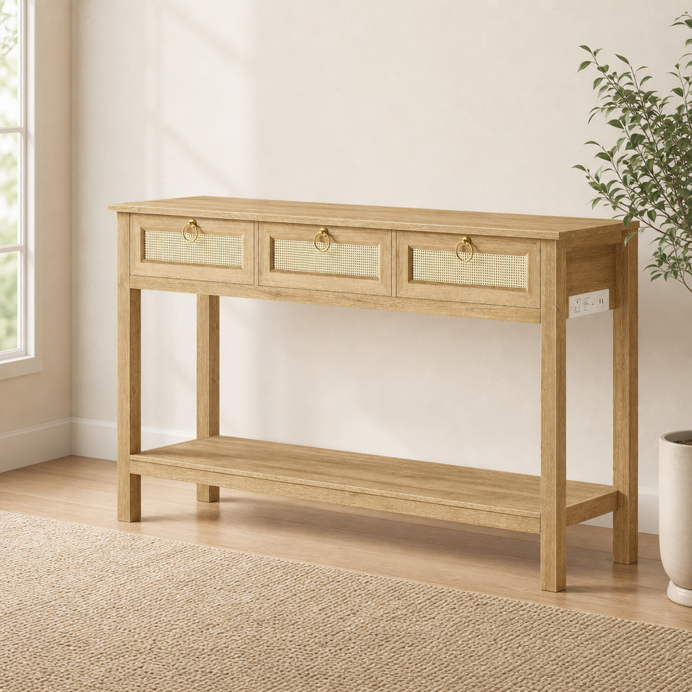 Light oak rattan console table front-left angle showing cane-front drawers and open lower shelf in a bright room