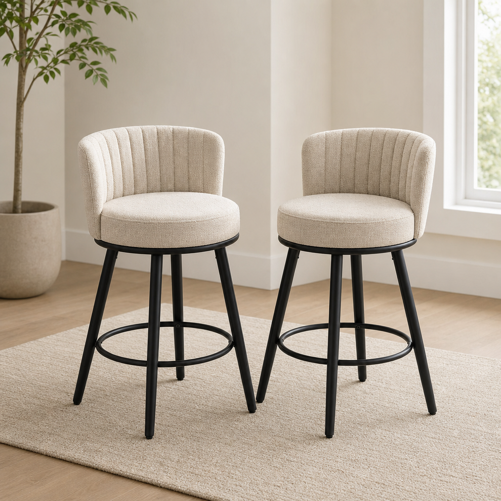 Beige upholstered swivel bar stools front view with rounded backs and black metal legs on a neutral area rug