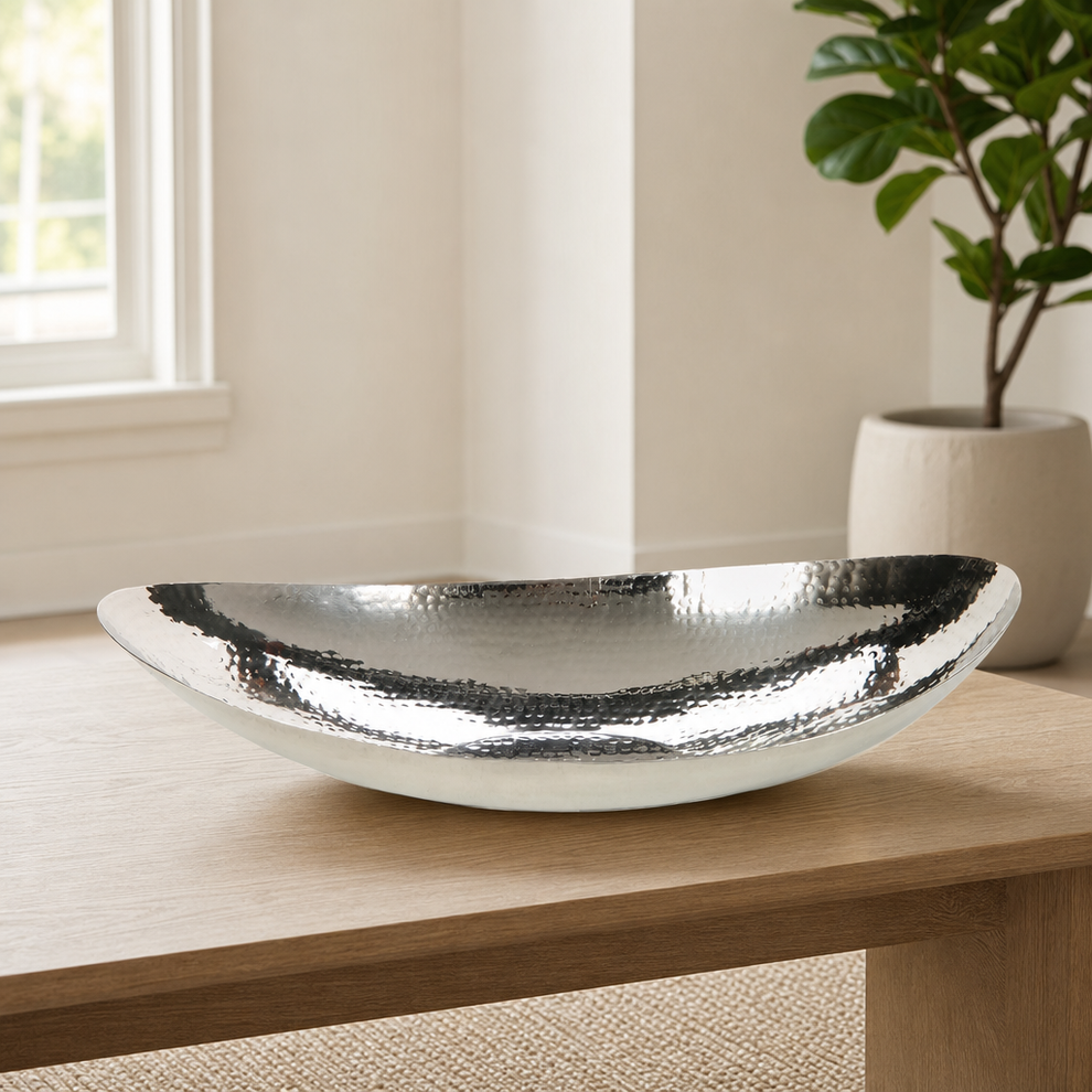 Hammered Stainless Steel Oval Bowl, 13.5-inch Tabletop Centerpiece centered in a warm neutral furnished room