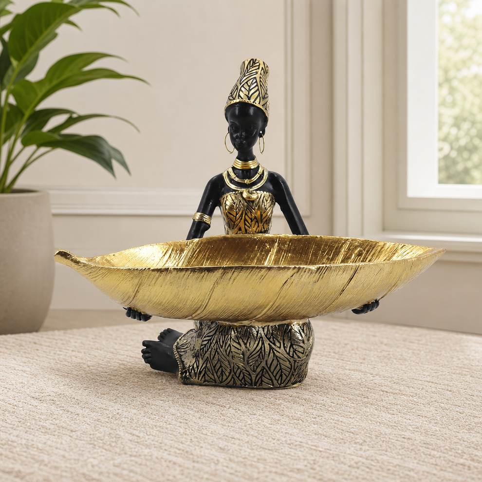 African Woman Resin Tray Statue, Gold Leaf Finish centered in a warm neutral furnished room