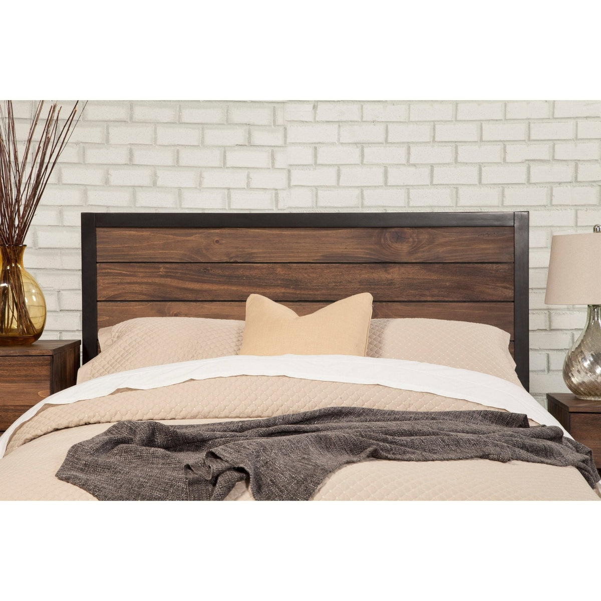 Close front view of the bed's dark wood headboard and black frame